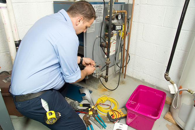 HVAC tech repairing gas furnace.jpg