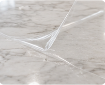 Applying premium stone protection film to a marble benchtop for invisible surface protection.