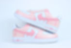 Side view of Pink Drip custom Nike Air Force 1 sneakers with vivid pink paint dripping over clean white leather base