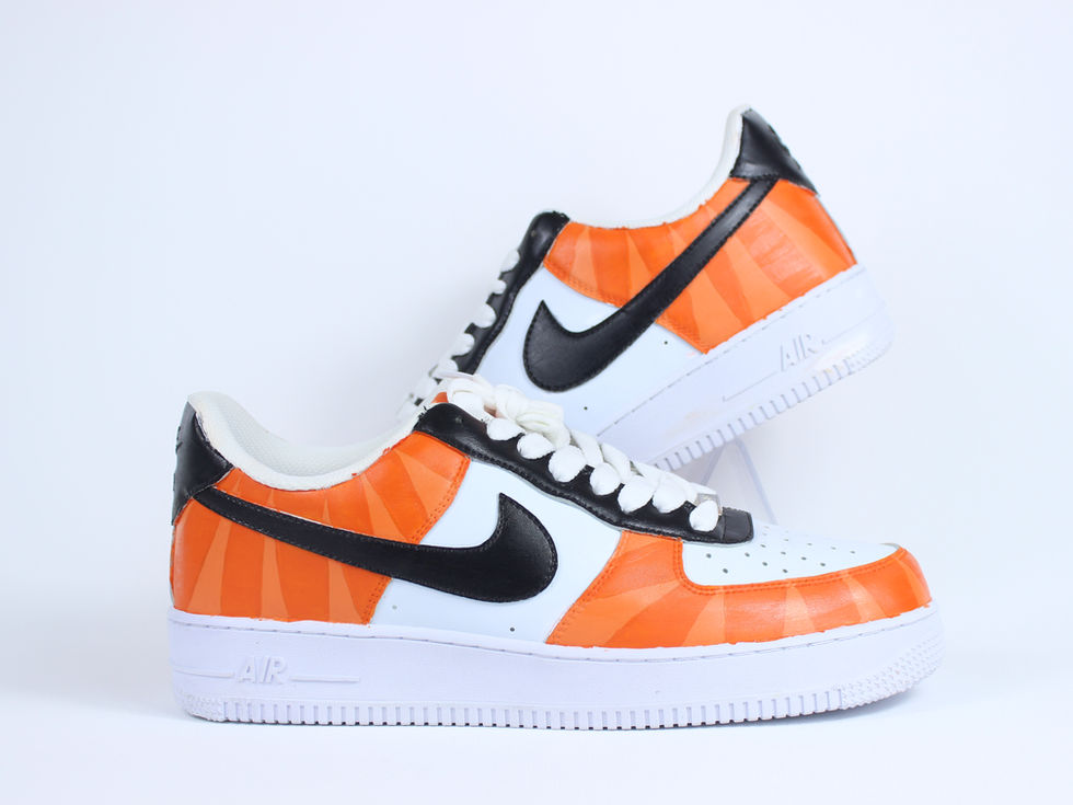 Side view of Orange Stripe custom Nike Air Force 1 sneakers with bright orange painted stripes over clean white leather base