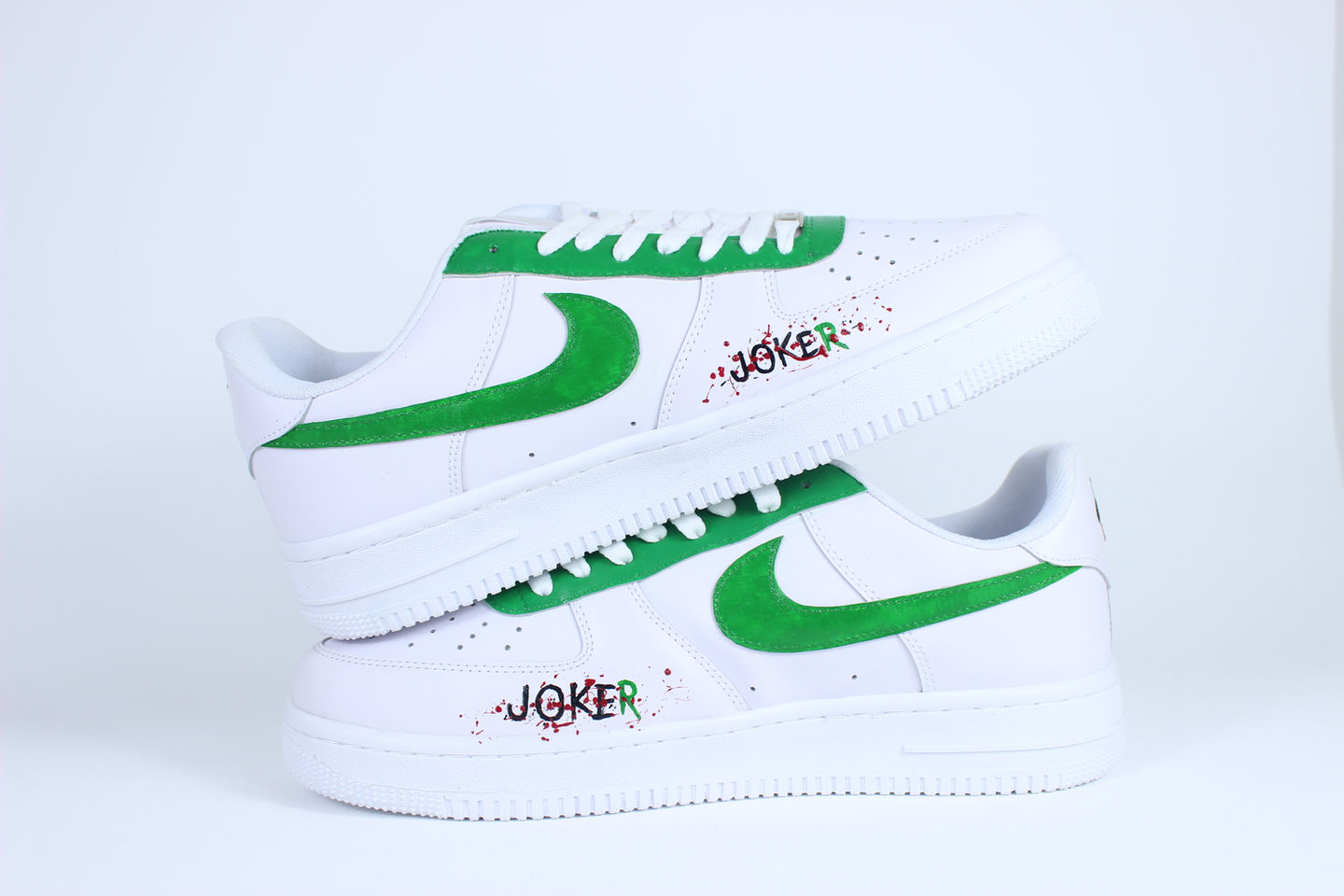 Side view of Joker-themed custom Nike Air Force 1 sneakers with green, purple, and red accents, chaotic brush strokes, and vi