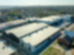aerial view of one white and one charcoal warehouse