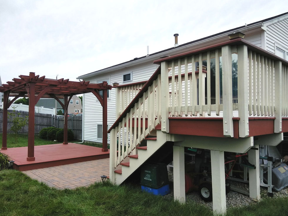 Two-level backyard deck with stairs and white railing