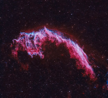 The Veil Nebula is a cloud of heated and ionized gas and dust in the constellation Cygnus. It constitutes the visible portions of the Cygnus Loop, a supernova remnant, many portions of which have acquired their own individual names and catalogue identifiers.