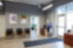 Modern office waiting area with chairs and water cooler