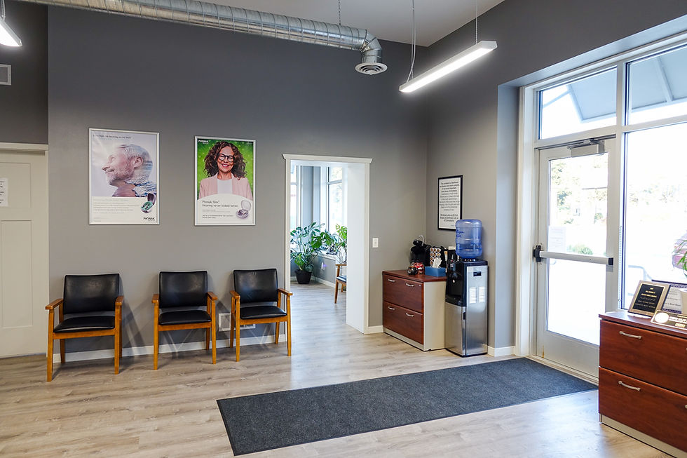 Waiting room with black chairs and posters on gray walls
