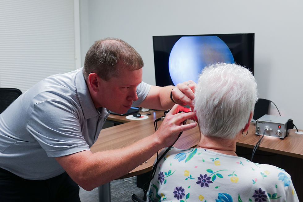 Specialist performing an ear exam with a video otoscope.