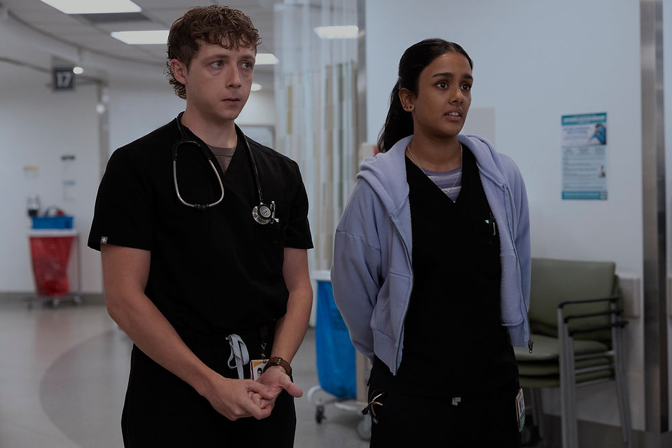 Two medical professionals in a hospital setting, one wearing black scrubs and stethoscope, the other in a lavender hoodie, appear focused.