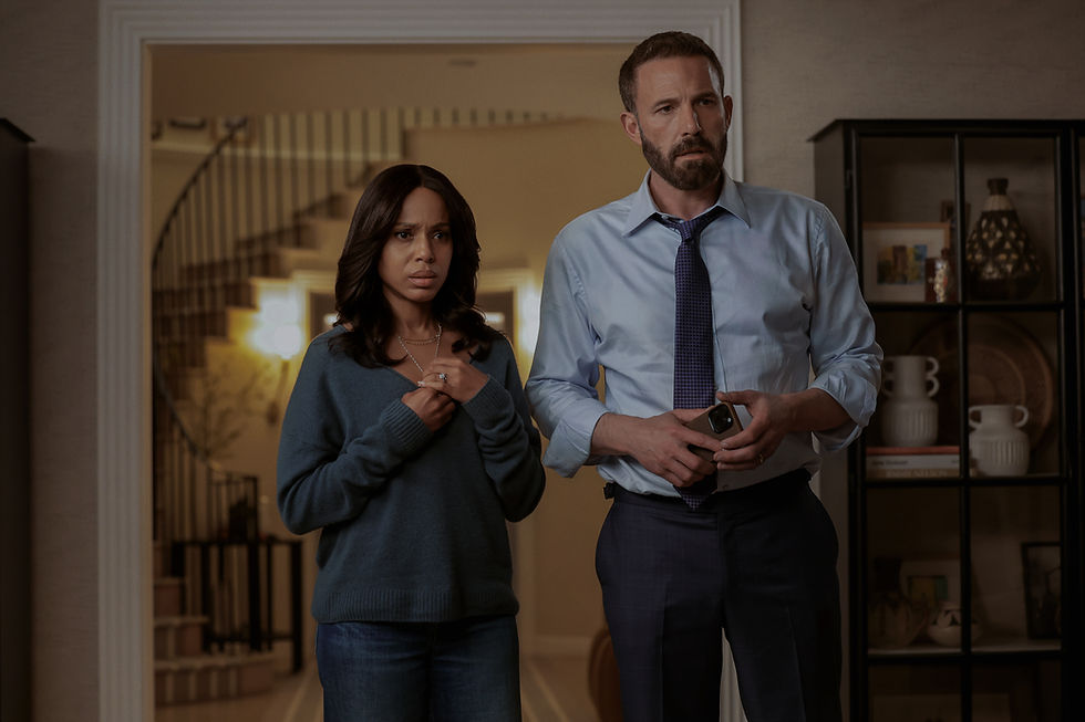 Concerned man and woman stand in a warmly lit home doorway; he holds a phone, both look tense.
