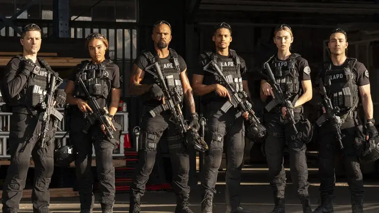 Six LAPD tactical officers stand in a garage, holding rifles in black gear, looking serious and ready for action.