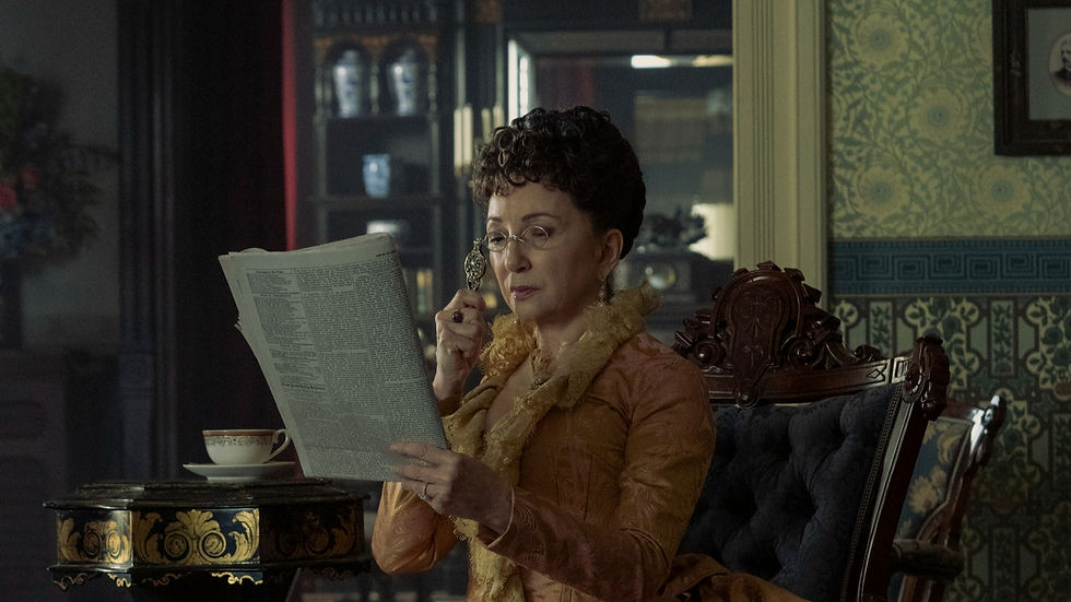 Woman in vintage attire reads a newspaper in an ornate room with patterned wallpaper. She holds a monocle, creating a focused mood.