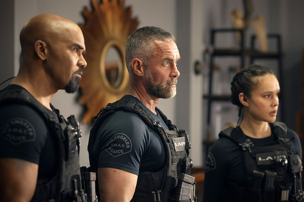 Three police officers in black tactical gear stand alert indoors, focusing intently. Gold sunburst mirror in the background, LAPD logos visible.