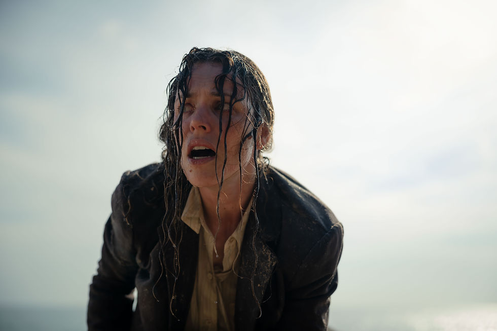 A drenched person with wet hair and an open mouth appears exhausted against a bright, cloudy sky. They wear a dark jacket and beige shirt.