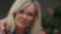 Close-up of a blonde woman in a red floral top, looking concerned in a softly lit room, with an ABC logo at bottom right.