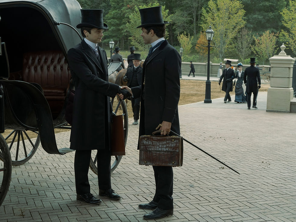 Two men in top hats shake hands beside a horse-drawn carriage. Paved street and trees in the background evoke a historical setting.