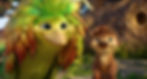 A colorful bird with leaf-like feathers and a furry creature smile warmly in a lush setting with a nest-like structure behind them.