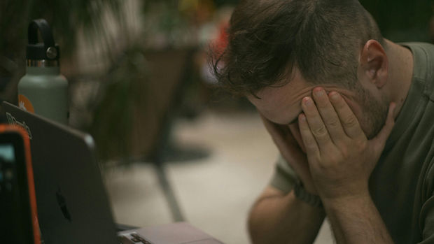 Man distressed, face in hands, during Substance Misuse Therapy