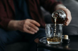 A man pouring whisky in to a glass