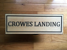 "Handcrafted wooden cottage sign with intricate carvings and a natural finish, displaying the name 'Cedar Lodge' in elegant lettering."