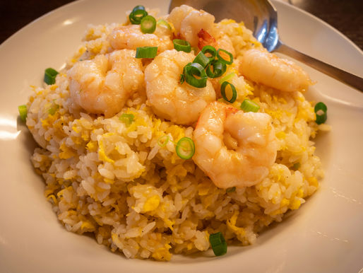 A plate of fried rice with shrimp.