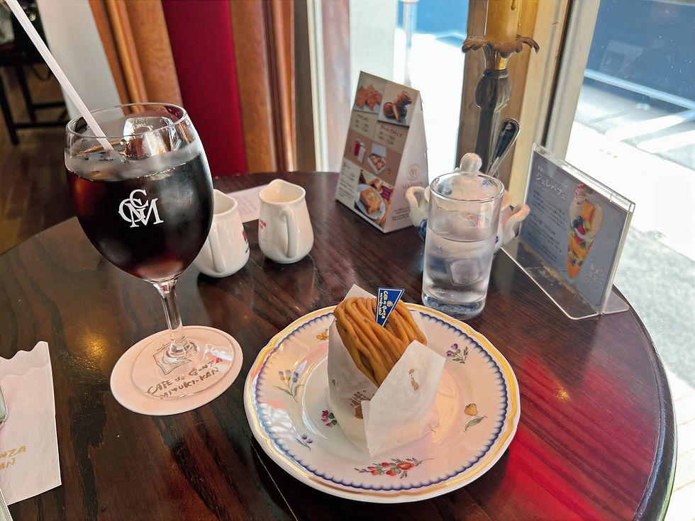 The mont blanc and ice coffee on a small wooden table.