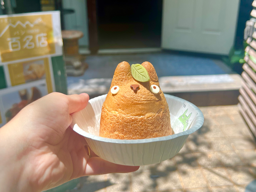 A Totoro-shaped cream puff on a white plate.