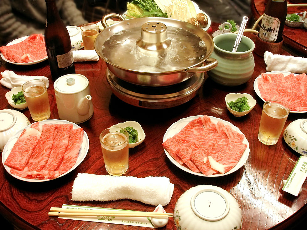 A traditional Shabu Shabu meal with meat, vegetables, and simmering dashi broth.