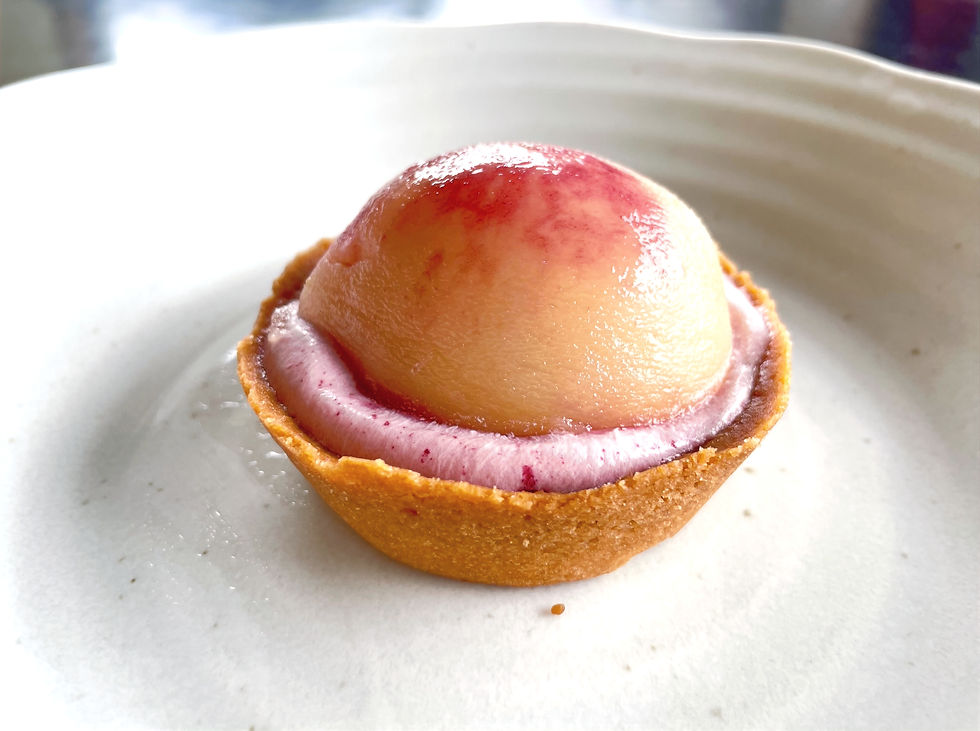 Seasonal peach tart with half a peach as the topping from Lawson.