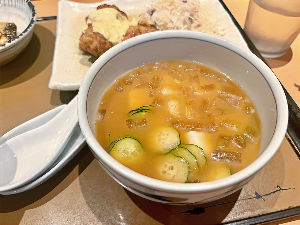 A bowl of hiyajiru (chilled miso soup) with cucumbers, tofu, and ice.