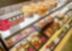 Ekiben display at tokyo station featuring various bento with lots of different dishes like meat and vegetables.