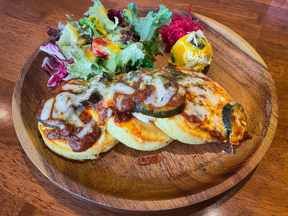 The bolognese pancakes with a side salad on a wooden plate. Warm, inviting atmosphere.