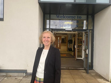 Susan smiling outside of Bearsden Academy.
