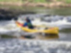 Paddler in a yellow canoe during open canoe coaching.