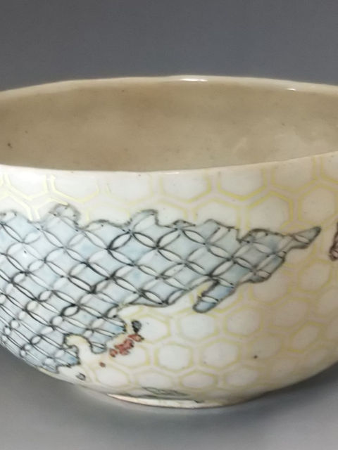 蜂の巣模様の地に青とピンクの七宝つなぎを描いた丼。正面