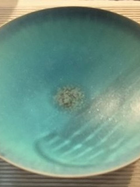 ターコイズブルーの釉薬の平鉢。中央に濃い斑点がある