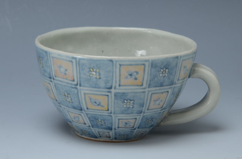 青い地に小花を描いた市松文様の染付カフェオーレ碗