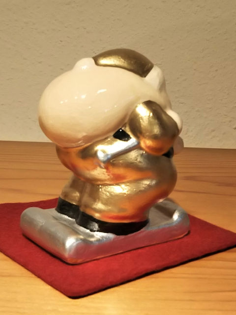 金色のサンタクロースの置物を後ろ斜めから見た様子