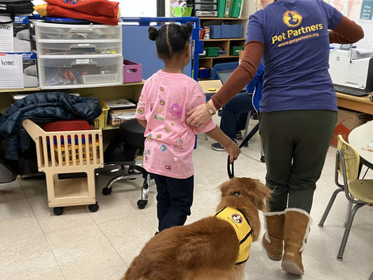 Therapy dog Tori and her handler guide a student