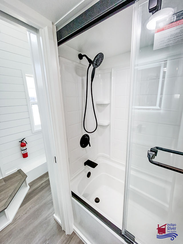 Interior shot of 32' Tiny Home on Wheels built by Indigo River Tiny Homes full-size bathroom shower