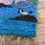 Thumbnail: Hand felted details of a seal added to a wall hanging weaving