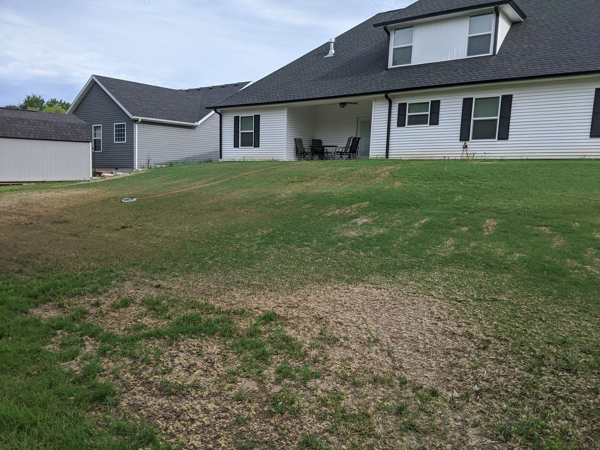 green lawn on hill house back patio
