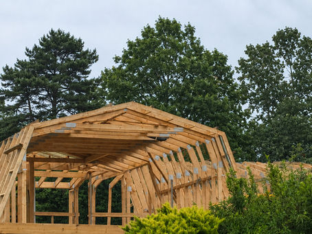 AI-assisted edit of a timber-frame construction site in Farnham, Surrey