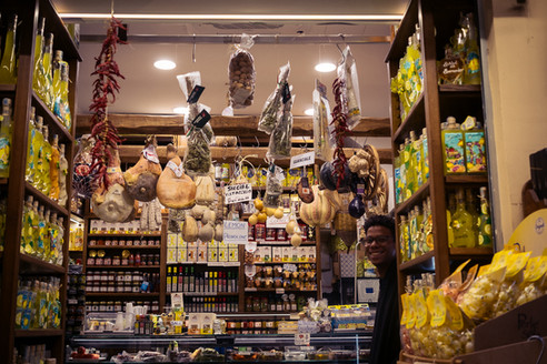 Italian deli packed with local produce including guanciale, provolone and limoncello bottles, Sorrento, Italy