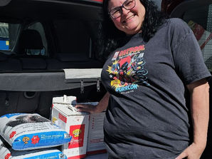 ARPO foster mom picks up litter.