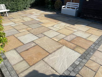 Stone patio with varied colors and patterns; Artisan Landscaping creates this design.