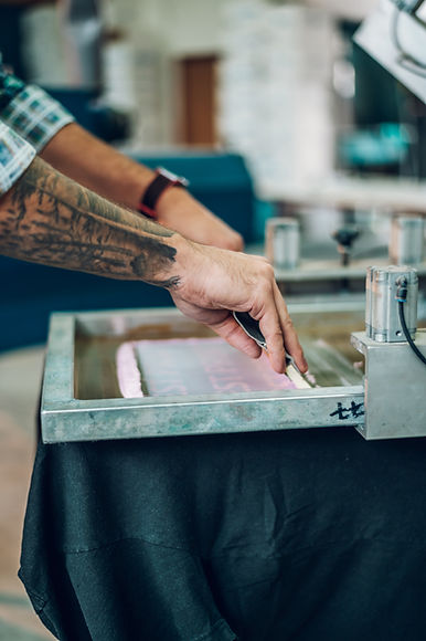male-worker-pressing-ink-on-frame-while-using-the-2022-04-18-23-16-34-utc.jpg