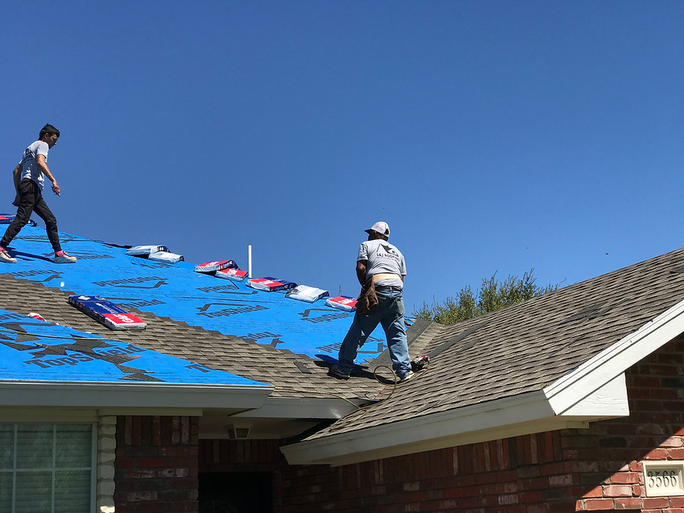 L&J workers installing shingles on a roof