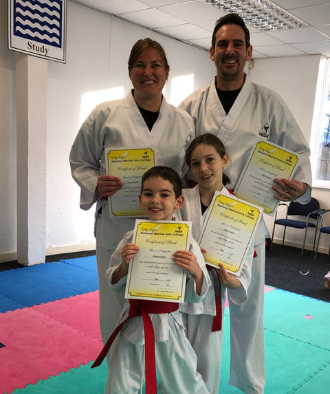 Family smiling after martial arts graduation