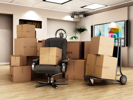 Office filled with packed cardboard boxes and a chair.
