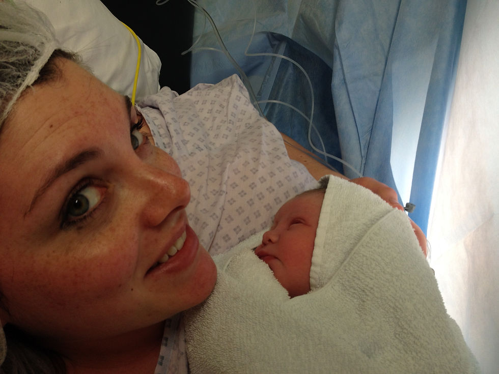 A picture of me in hospital with my second born son wrapped in a towel